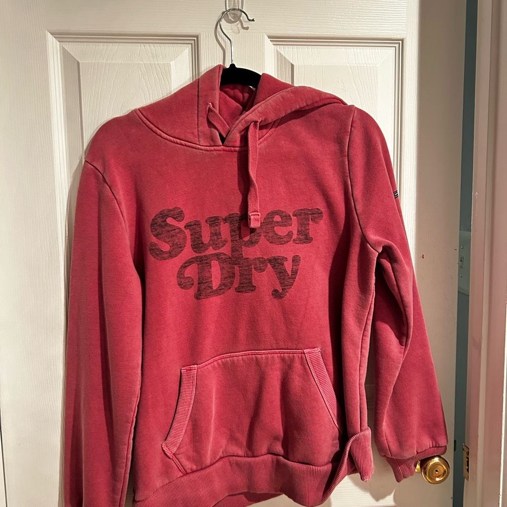 This product is a Rusty Pink SuperDry hoodie in a size 8 in women's.